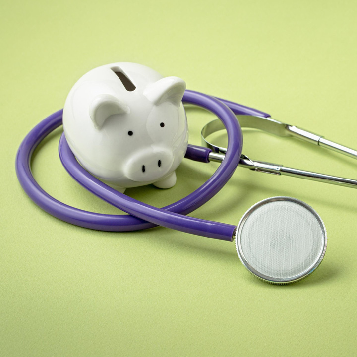 Piggy bank with a stethoscope wrapped around it